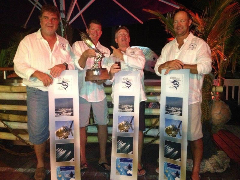 Game boat winning crew showing off their trophy